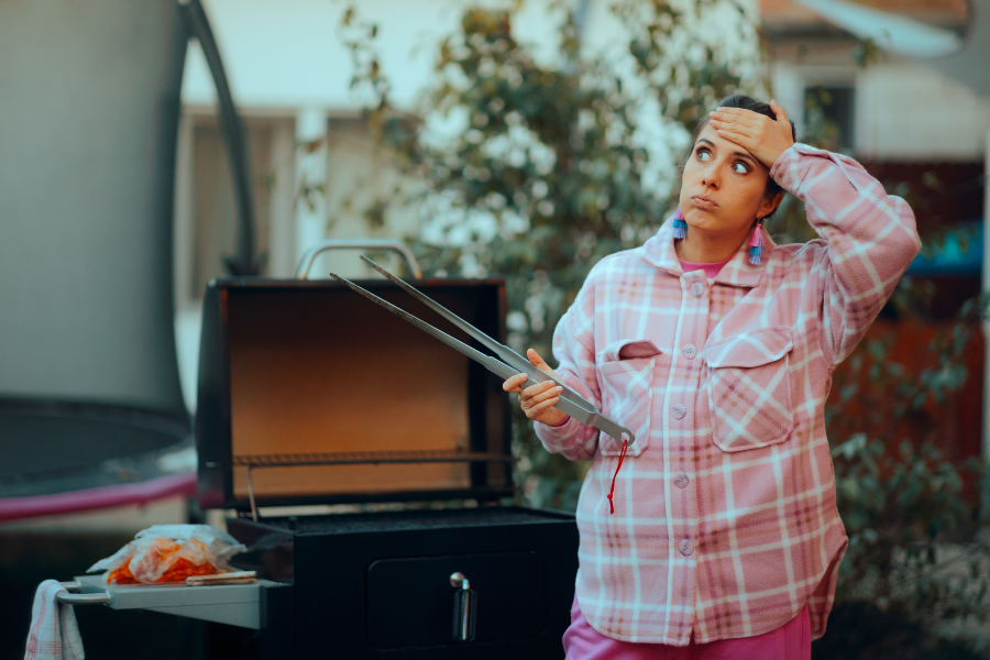 Problème avec un barbecue électrique – diagnostic et solutions avec Gitem Femme contrariée devant un barbecue en panne qui ne chauffe pas